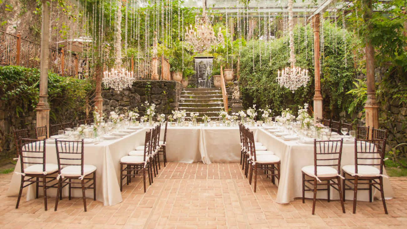 U shaped table set up for a meal in a greenhouse orangery