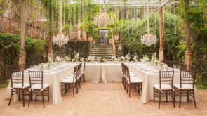 U shaped table set up for a meal in a greenhouse orangery