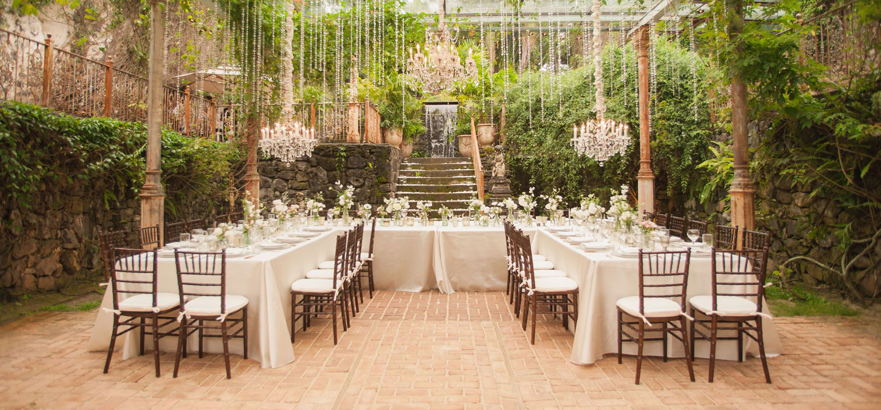 U shaped table set up for a meal in a greenhouse orangery