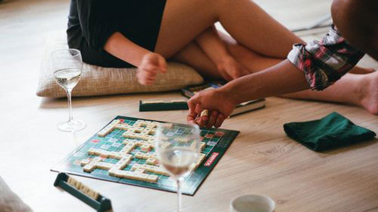 2 people playing scrabble on the floor