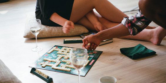2 people playing scrabble on the floor