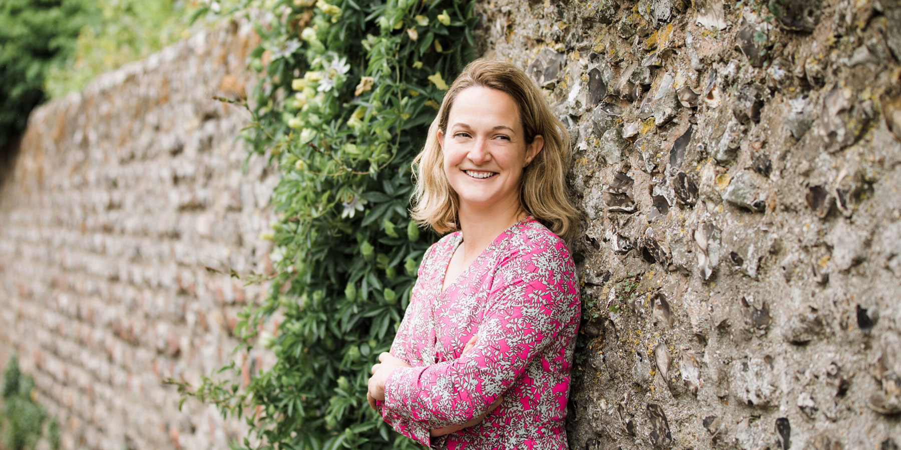 Lucy Hall of Lucy Claire Events leaning against a wall