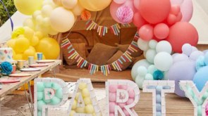 Summer party with colourful balloons and letters spelling out party