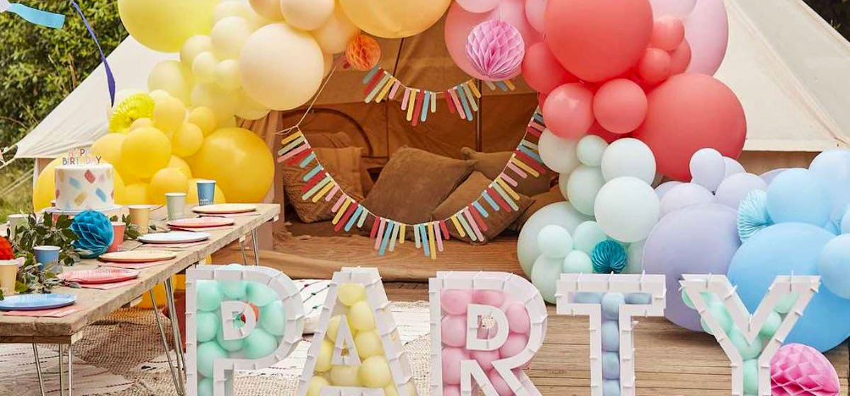 Summer party with colourful balloons and letters spelling out party