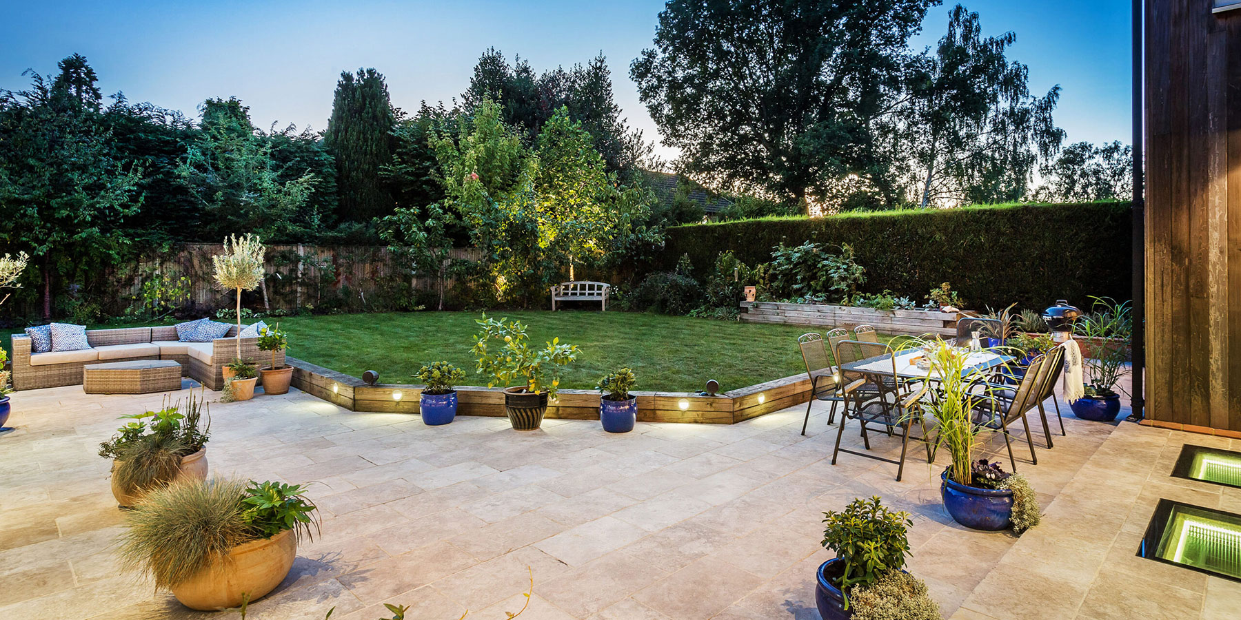 Large garden with seating and fairy lights