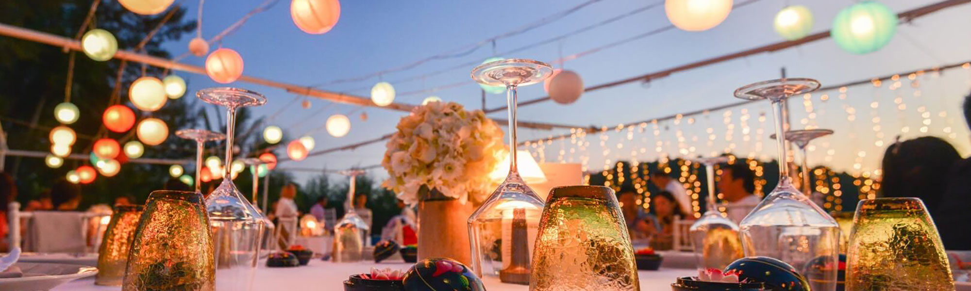 Close up of glasses set up on a table at sunset
