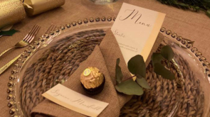 Dinner setting with a personalised name card with a napkin folded around it