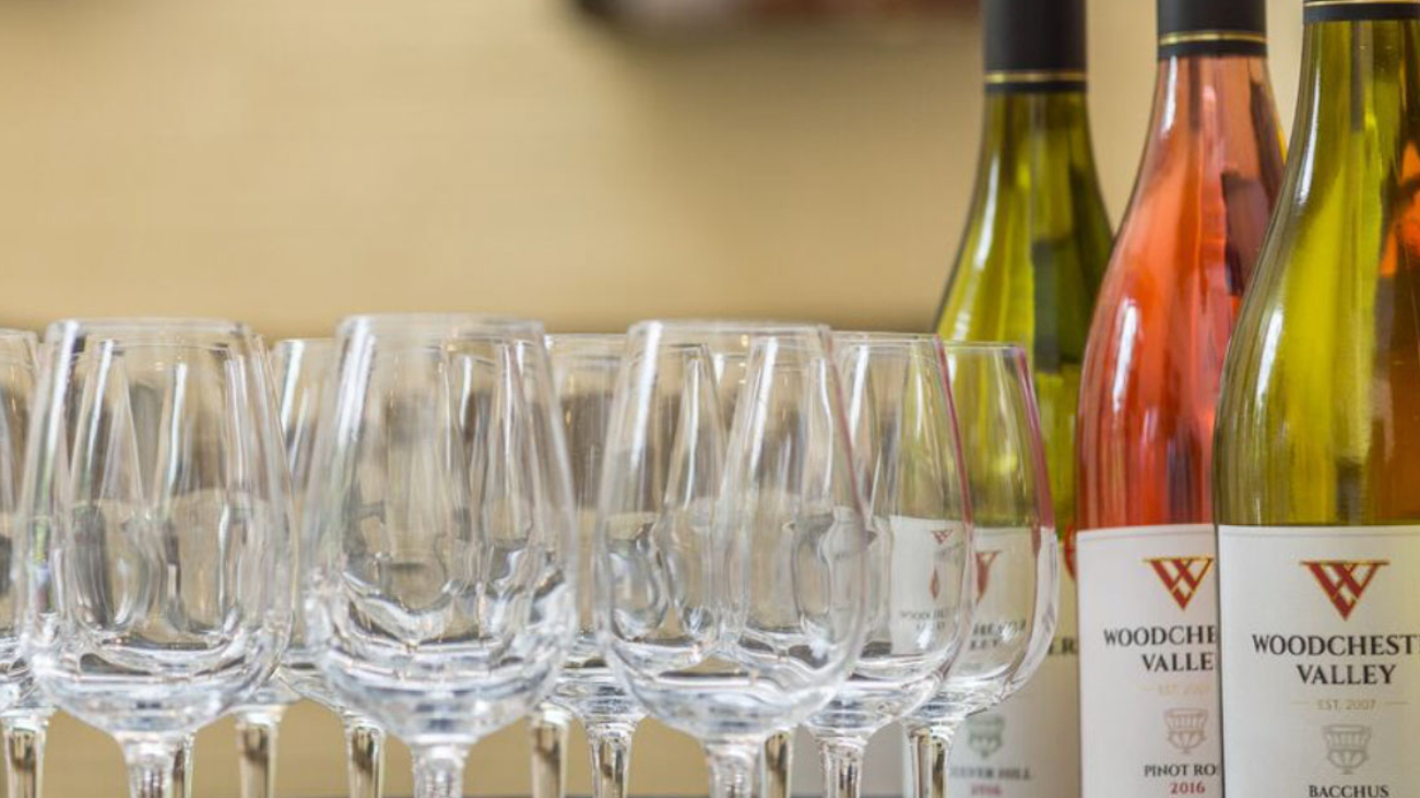 Woodchester Valley wine bottles sat on a table next to some wine glasses