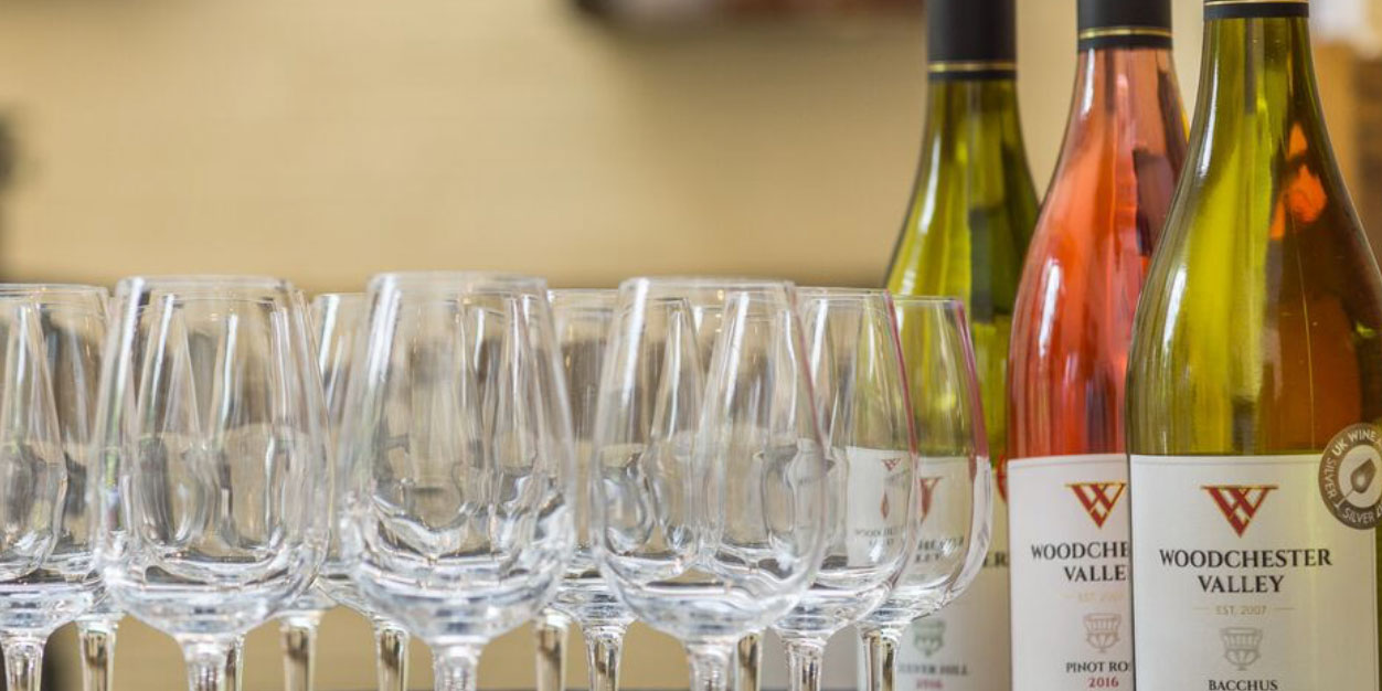 Woodchester Valley wine bottles sat on a table next to some wine glasses