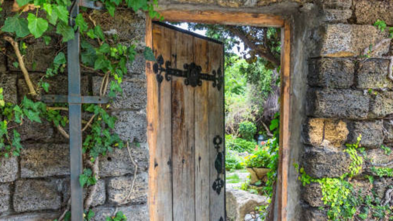 Wooden doorway into a walled garden