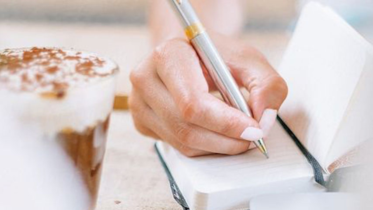 A woman writing in a notebook
