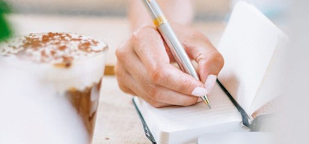 A woman writing in a notebook