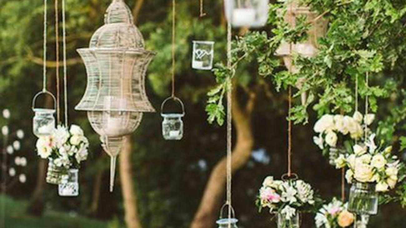 Lanterns and flower arrangements hanging from a tree
