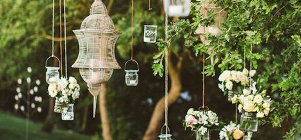 Lanterns and flower arrangements hanging from a tree