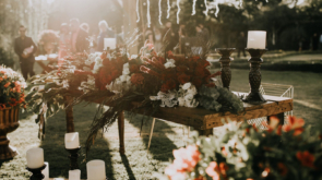 An outdoor table covered in floral arrangements