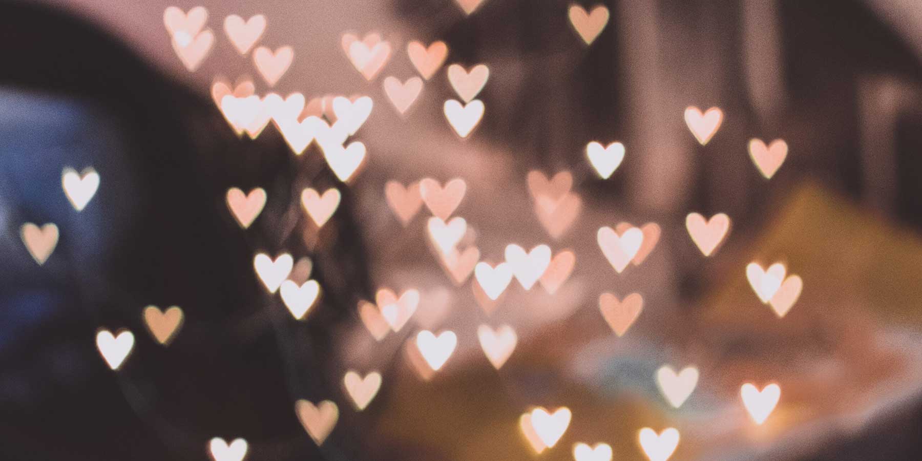 Hearts created from light in front of a blurred background