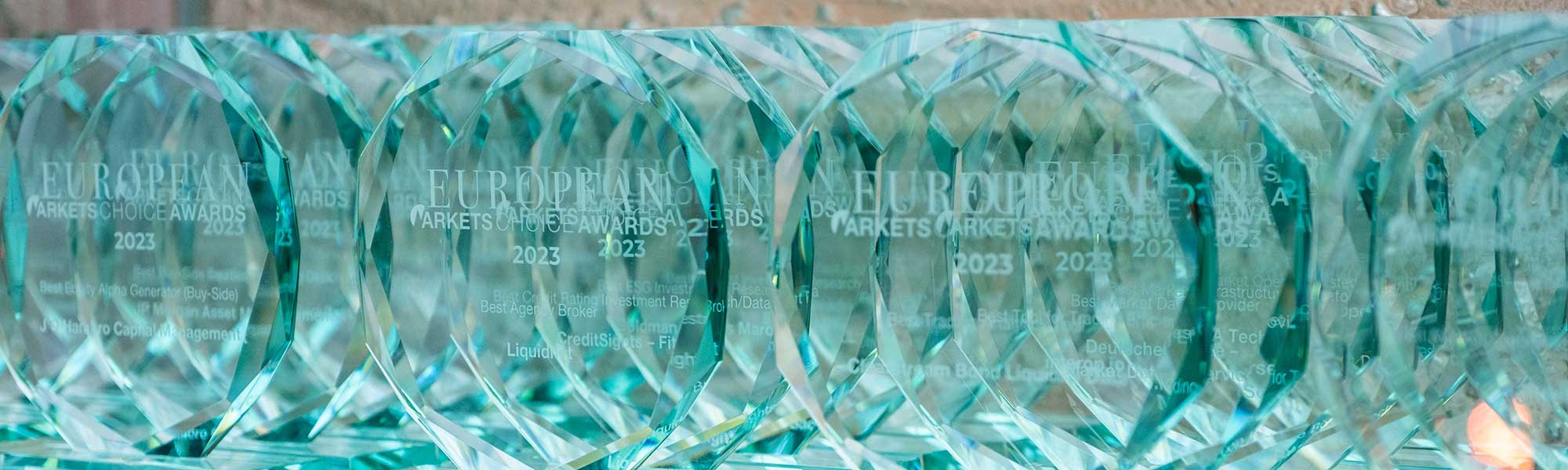 Glass awards displayed together before collection