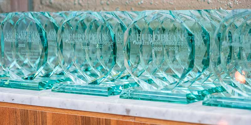 Glass awards displayed together before collection