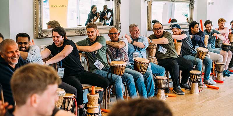 A company team building event with bongo drums